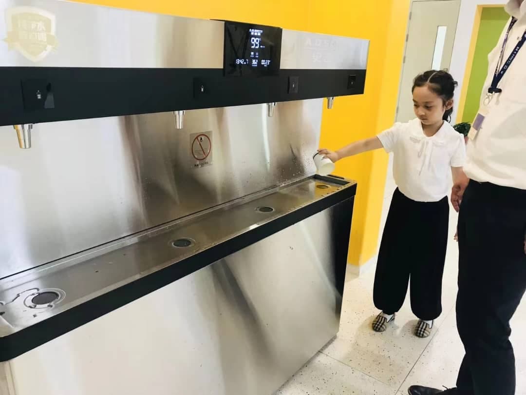 Students and community members using a water station